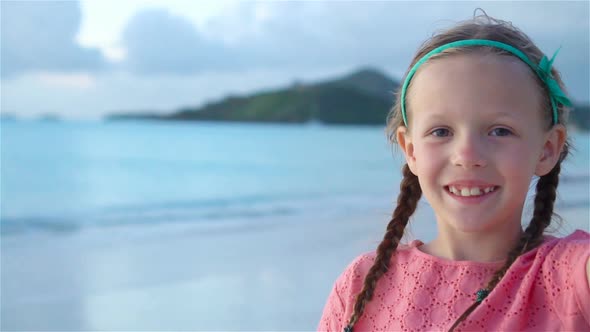 Adorable Little Girl Making Selfie at Tropical White Beach. SLOW MOTION