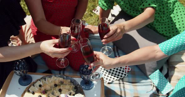 Girls On A Picnic Knocking Over Glasses Of Wine