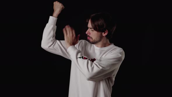 Trendy Young Man flexing biceps, show off gesture, muscles, wide, black background