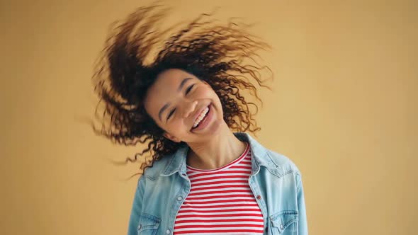 Funny Slow Motion Portrait of Joyful Girl Moving Head Waving Hair Laughing