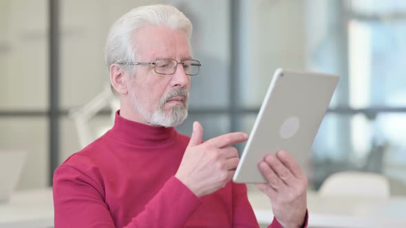 Old Man Using Digital Tablet