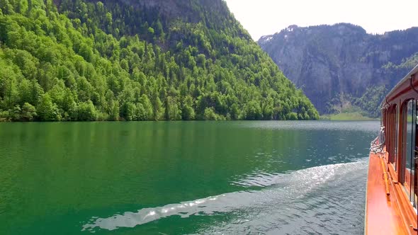 Flowing boat on the lake Konigssee in Germany, the Alps