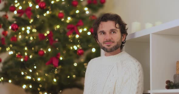 Man With Present in the Gift Box Near Christmas Tree at Home