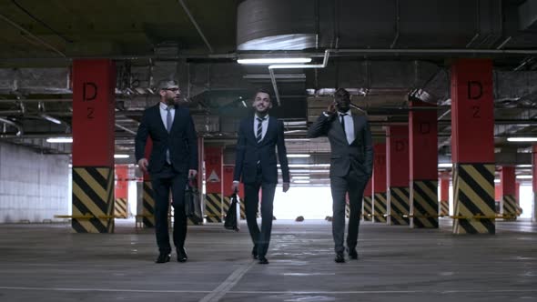 Businessmen Walking in Underground Parking Lot