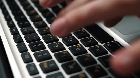 Close Up Man Hands Typing on Laptop Keyboard Sitting at the Table at Home or Office