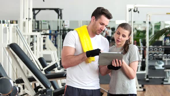 Young People Using Digital Tablet at Gym.