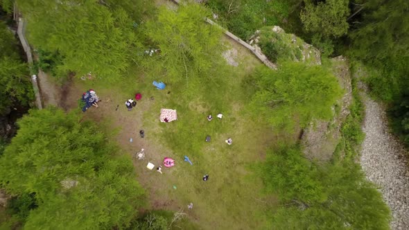 Zoom out with a drone from a green plain in the swiss alps, aerial shot