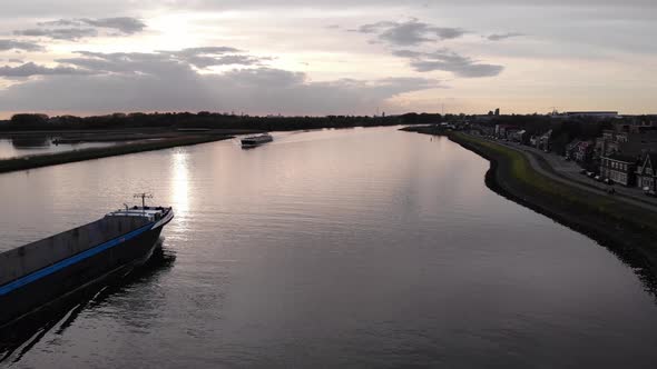 Ship Sailing With Empty Storage Deck Against Sunset Sky In The Waterways Of South Holland In Netherl