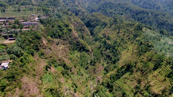 Terraced fields at Umbul Sidomukti valley in Ambarawa, Indonesia. Aerial flyback