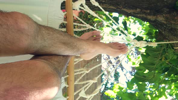 POV Point of View of Man Relaxing on Hammock in a Luxury Resort