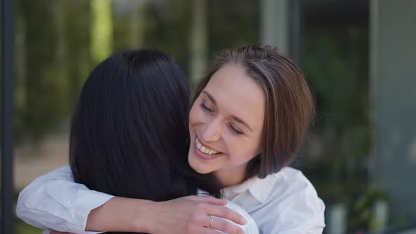 Happy Woman Hugging Friend Smiling Looking at Camera in Slow Motion