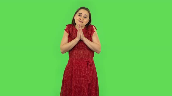 Tender Girl in Red Dress Is Keeping Palm Together and Asking for Something. Green Screen