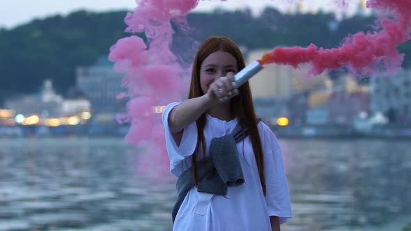 Smiling Female Teenager Waving Color Smoke Bomb Outdoors, Life Celebration