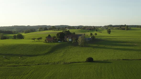 Aerial establishing shot of small hamlet of houses in Europe using solar power