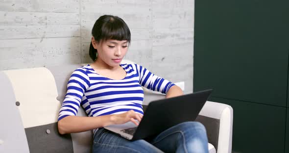 Woman typing on notebook computer