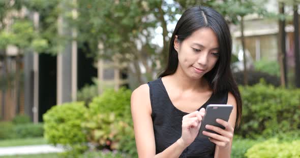 Woman using mobile phone at outdoor 