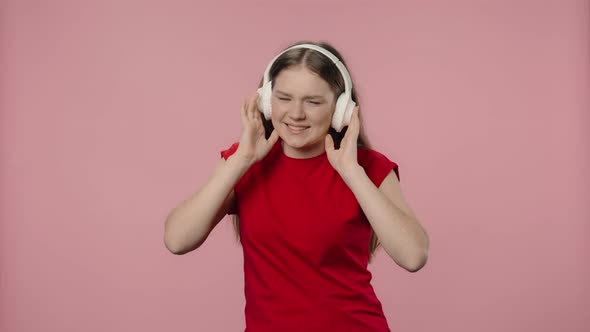 Portrait of Fashion Model Enjoying Music in Big Wireless White Headphones