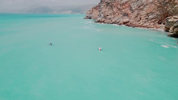 Family Paddleboarding Down the Sea