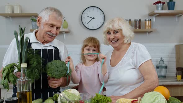 Girl with Mature Man and Woman Recommending Eating Raw Vegetable Food. Healthy Nutrition Diet