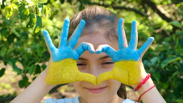 The Ukrainian Flag is Drawn on the Child Hands