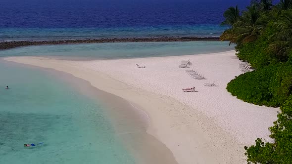 Aerial tourism of shore beach break by blue sea and sand background