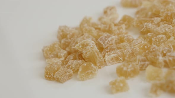 Slow pan over crystallized Zingiber officinale cubes on pile  4K 2160p 30fps UltraHD footage - Piece