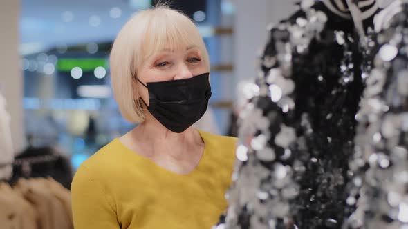 Caucasian Middle Aged Woman in Medical Mask Customer Client in Clothing Store Looking in Surprise at