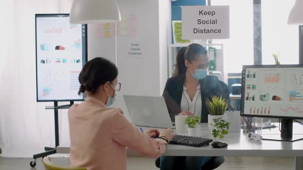 Group of Business People with Face Masks Working in New Normal Company Office