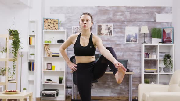 Young Woman Standing in One Foot on Mat