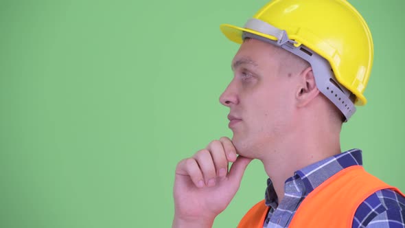 Profile View of Happy Young Man Construction Worker Thinking