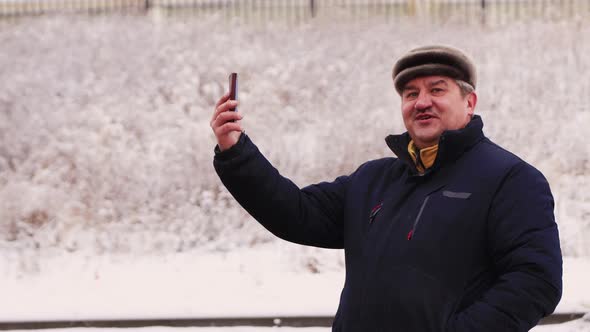 Happy Business Man Talking Online on a Smartphone By Video Call