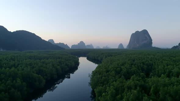 Aerial view drone shot of beautiful sunrise sky in the morning sunrise over sea and mangrove forest