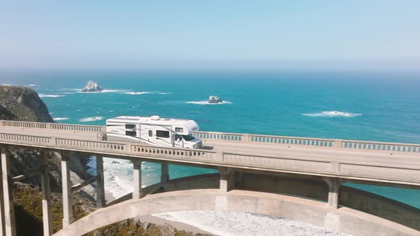 Aerial RV Driving By Road on American Road Trip with Cinematic Ocean Background