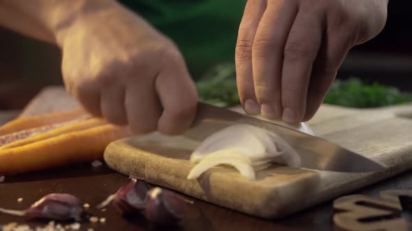 Chef Chops the Onions on the Wooden Board at the Kitchen, Raw Vegetables