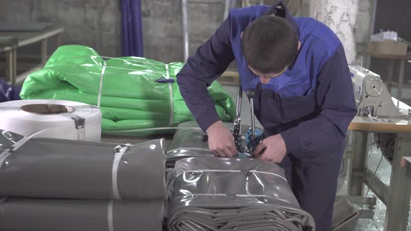 Man Warehouse Worker Is Engaged in the Packaging of Plastic Awning