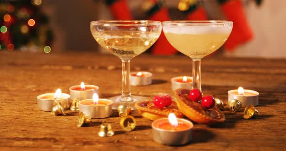 Wine glasses with christmas decorations on wooden table