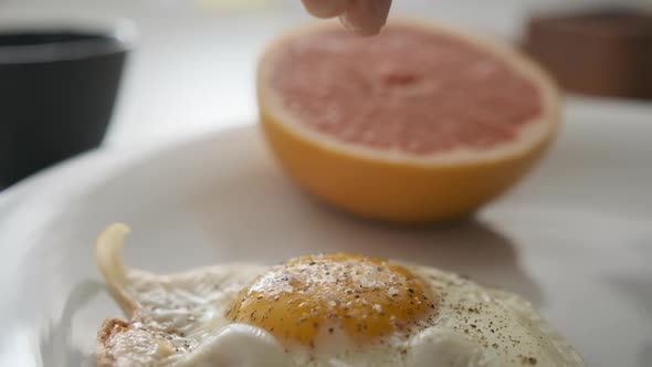 Mouth-watering Breakfast Served with Egg and Grapefruit on Side in Slow Motion