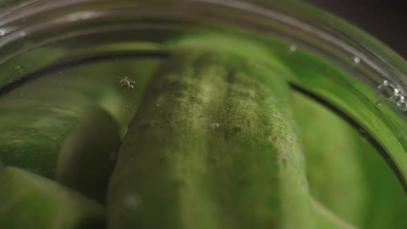 Macro Air Bubbles Rise From Cucumber Jars for Marinade Making Filled with Boiling Water