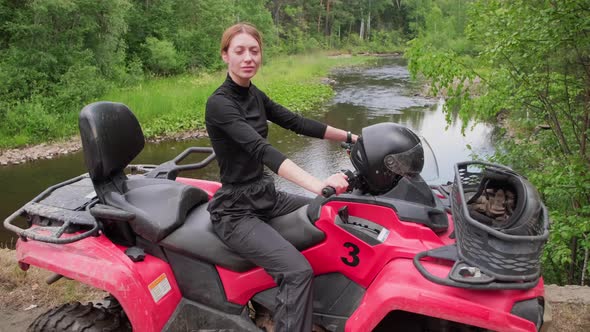 Woman Posing on Quad Bike in Forest