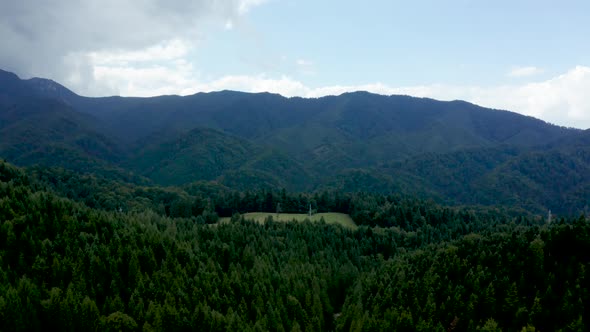 Ariel Footage Over Mountain with Green Forest