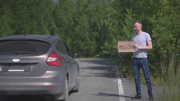 Man Catches a Passing Car