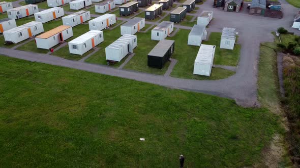 Shooting From a Drone of a Working Camp Near a Farm