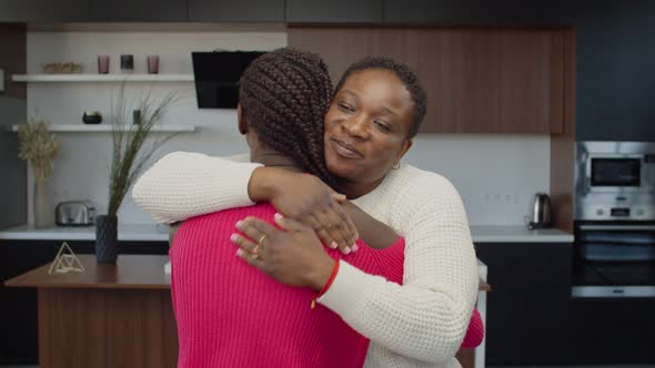 Caring Black Mother Embracing Teenage Daughter Indoor