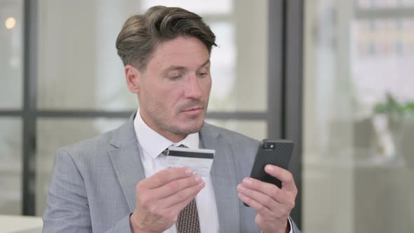 Middle Aged Man having Online Payment Success on Smartphone