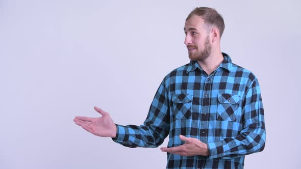 Happy Bearded Hipster Man Showing Something