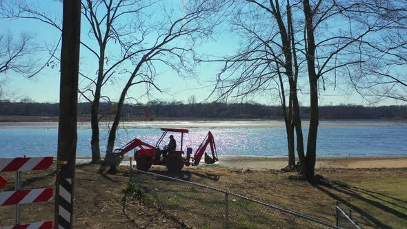 ‎⁨A low angle view of Rancocas Creek on a sunny day. The camera dolly in towards a man operating a t