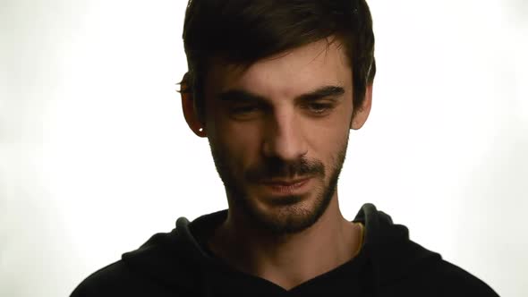 Portrait of a Young Man Who Coughs and After Wears a Medical Mask on Face on a White Background 