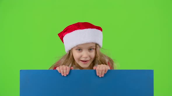 Baby Jumps Out From Behind the Blue Board and Shows a Thumbs Up. Green Screen