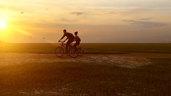 Couple Taking a Bicycle Tour at Sunset