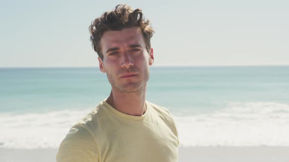 Caucasian man looking at the camera at beach